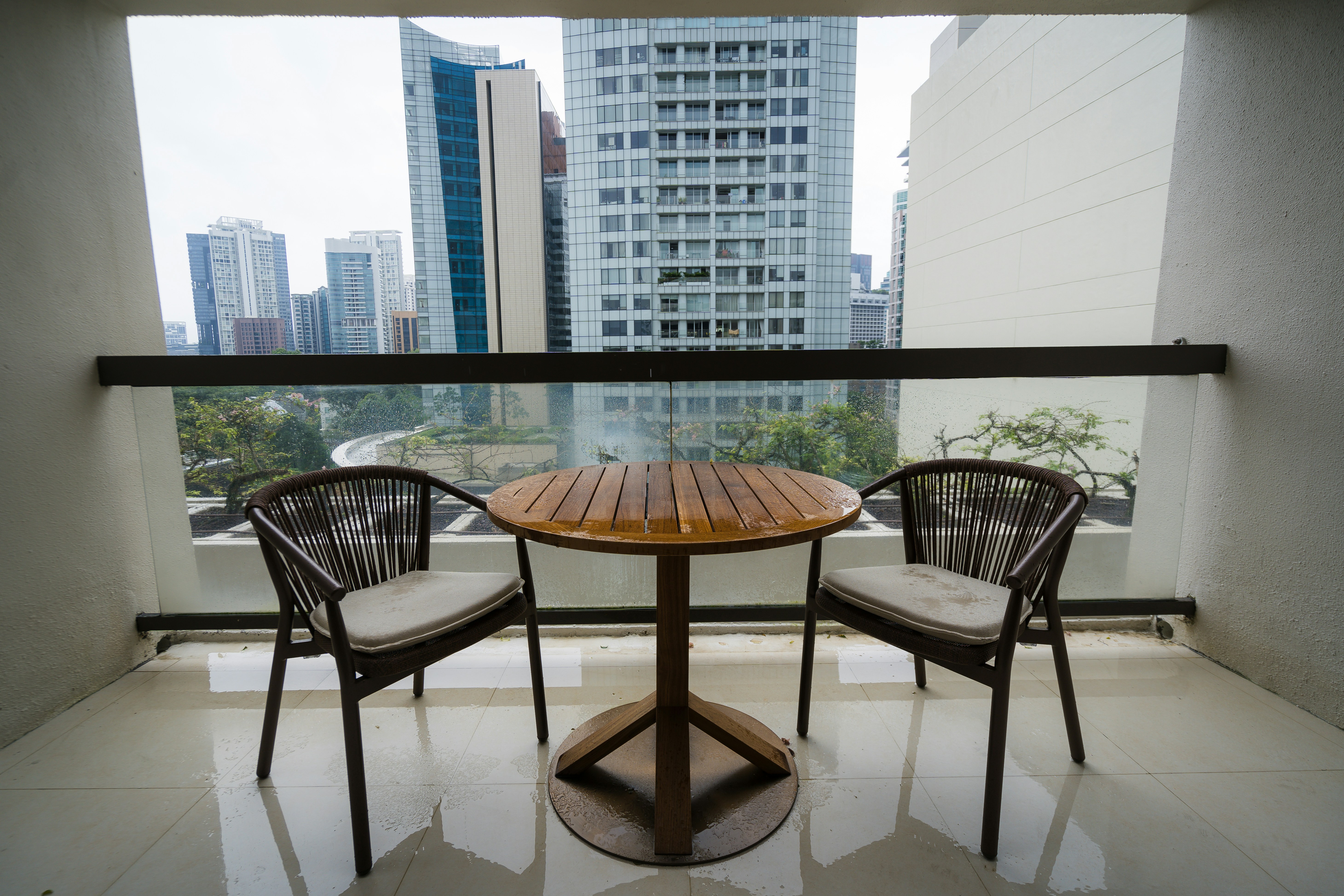 Two chairs and a table on a balcony
